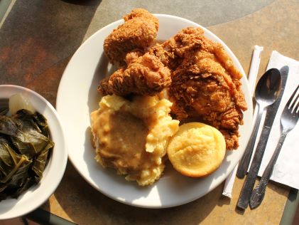 A plate of soul food like fried chicken and collard greens
