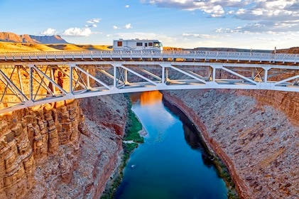 Beautiful aerial shot of a recreational vehicle driving on a bridge over the Colorado River