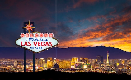 A stunning shot of the world famous Las Vegas sign with the city skyline in the background