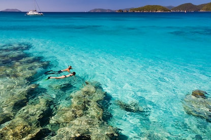 A couple snorkeling in the crystal clear waters of the Caribbean