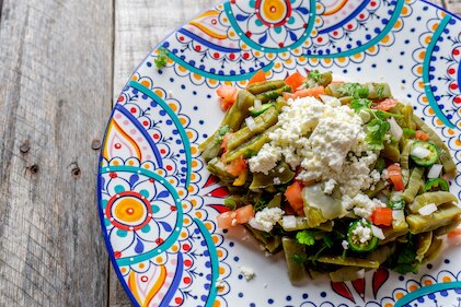 Traditional Mexican nopal cactus salad with cheese on a decorative plate