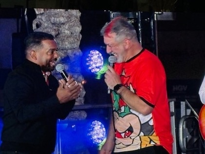 Entertainers Joey Fatone and Alfonso Ribeiro sing into microphones on stage at an event at Elara, by Hilton Grand Vacations in Las Vegas, Nevada
