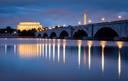 Twilight visual of the Arlington Memorial Bridge over the Potomac River with the National Mall in the background, Washington, D.C.