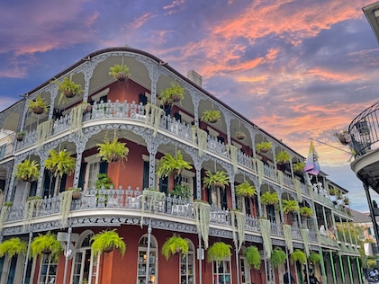 A beautiful three-story building with wrap-around balconies on Bourbon Street, New Orleans, Louisiana