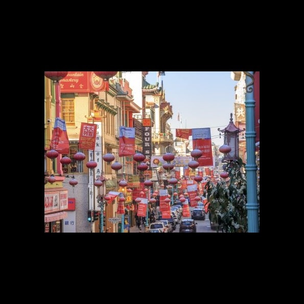 Chinese lanterns hanging overhead a Chinatown street at dusk, San Francisco, California.