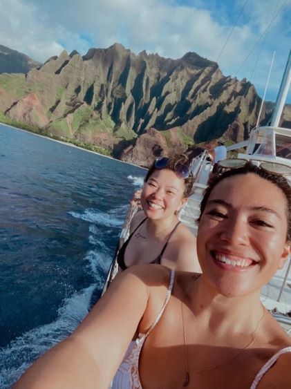 A Hilton Grand Vacations Member takes a selfie while on a catamaran on Kauai's Na Pali Coast in Hawaii