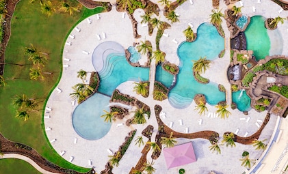 Aerial view of the lush, manicured grounds and large resort-style pool at Maui Bay Villas, a Hilton Grand Vacations Club, Kihei, Hawaii