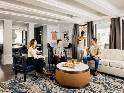 A group of friends hanging out in a Suite at The Quin, a Hilton Club in New York City