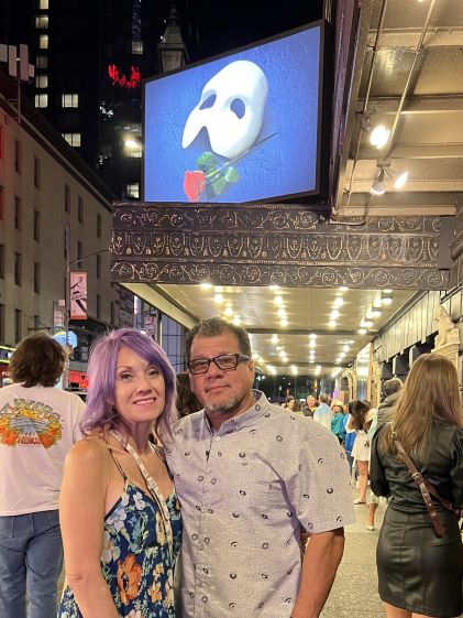 A Hilton Grand Vacations Member's in-laws outside of a theater showing "The Phantom of the Opera"