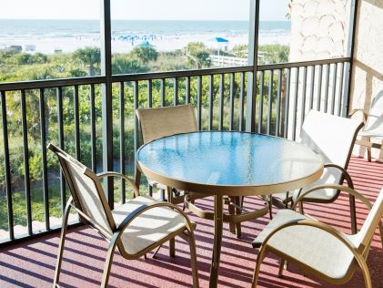 Four chairs and a table on a balcony of Club Regency of Marco Island in Florida