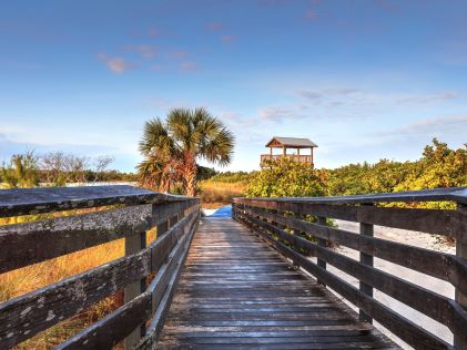 Wooden boardwalk over a beach at Marco Island, Florida