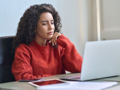 A woman researching on a laptop