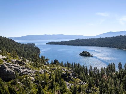 Aerial view of Lake Tahoe and its surrounding forested mountains in California