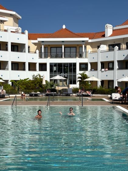A Hilton Grand Vacations Member and her friends at the pool at Hilton Vilamoura As Cascatas Golf Resort & Spa in Algarve, Portugal