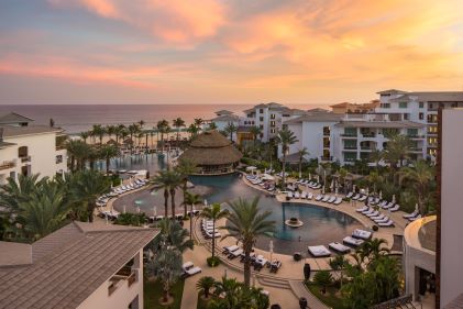 Sunset painted skies overhead stunning resort-style pool, Cabo Azul, A Hilton Vacation Club, Cabo San Lucas, Mexico. 