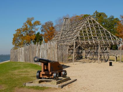 Cannon and historic building replica at Jamestown, Virginia