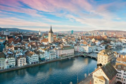 Gorgeous aerial view, snow-covered city, river running through, wintery painted skies overhead, Zurich, Switzerland.