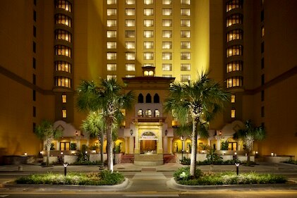 Nighttime image spanning upward from of the entrance to Anderson Ocean Club, a Hilton Grand Vacations property in Myrtle Beach, South Carolina