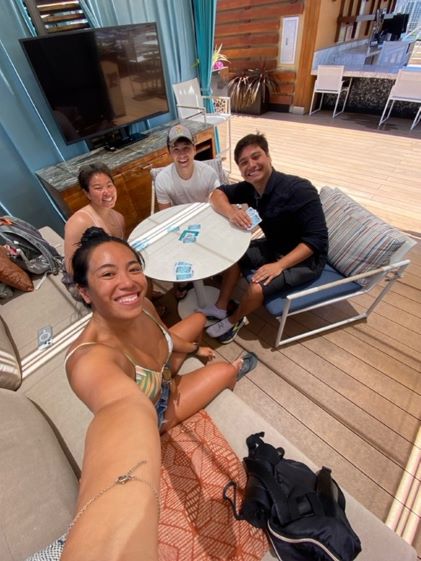 Hilton Grand Vacations Member posing with friends, group vacation, roof top pool, Hokulani Waikiki, a Hilton Grand Vacations Club, Oahu, Hawaii. 