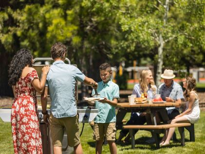 Two families enjoy a picnic together near Lake Tahoe, California