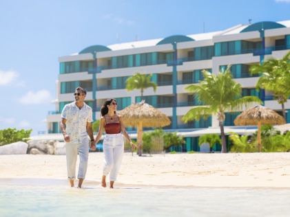 A couple walks on the beach at Royal Palm, a Hilton Vacation Club in Sint Maarten