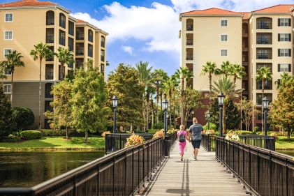 Hilton Grand Vacations Members, strolling boardwalk, blue skies, Tuscany Village, a Hilton Grand Vacations Club, Orlando, Florida. 