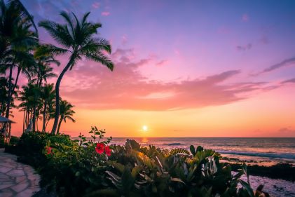 Sunset painted skies over ocean waves, Big Island, Hawaii. 