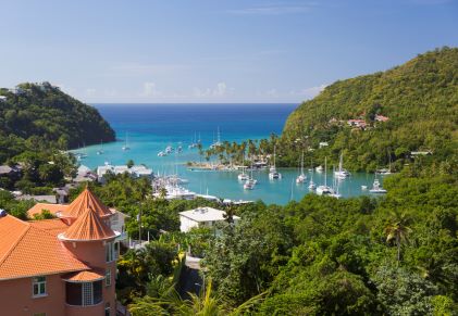 Idyllic tropical harbor, sailboat dotted waters, blue skies overhead, Saint Lucia. 