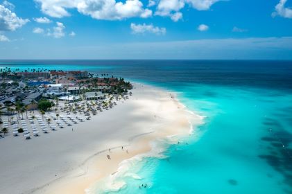 Aerial image, crystal clear turquoise water washes ashore white sands, Eagle Beach, Aruba. 