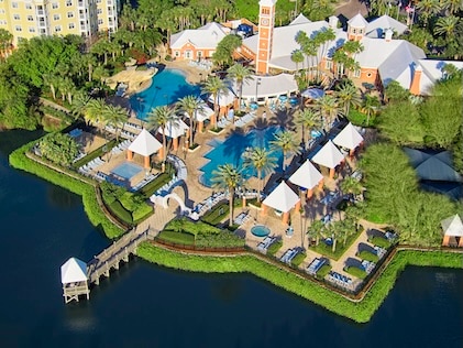 Drone view of the pool, cabanas and surrounding lake at SeaWorld Orlando, a Hilton Grand Vacations Club
