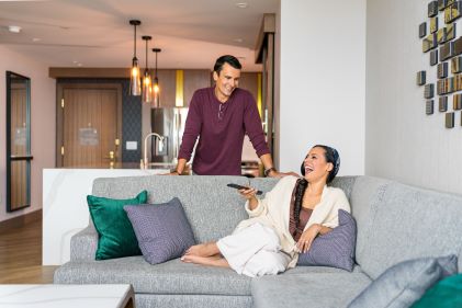 Couple enjoying Suite living space, Elara, a Hilton Grand Vacations Club, Las Vegas, Nevada. 