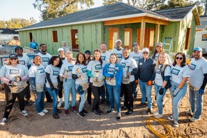 Hilton Grand Vacations Team Members smiling, group picture, construction site, HGV Serves Habitat For Humanity event, Orlando, Florida.