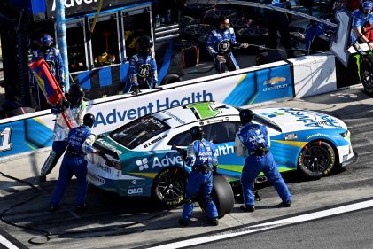 Pit crew changing tires, NASCAR race, HGV Ultimate Access. 