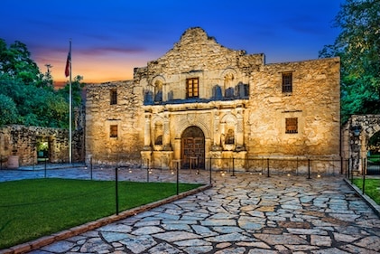 Street view of The Alamo in San Antonio at dusk.