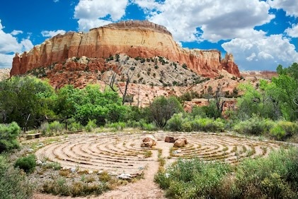 Labyrinth at Ghost Ranch, New Mexico with red rock outcropping in the distance.