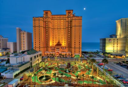 Anderson Ocean Club, a Hilton Grand Vacations Club glow against night sky, exclusive mini-golf course, Myrtle Beach, South Carolina. 