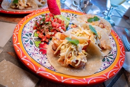 Close up of shrimp street tacos on colorful plate at restaurant in Cabo San Lucas, Mexico