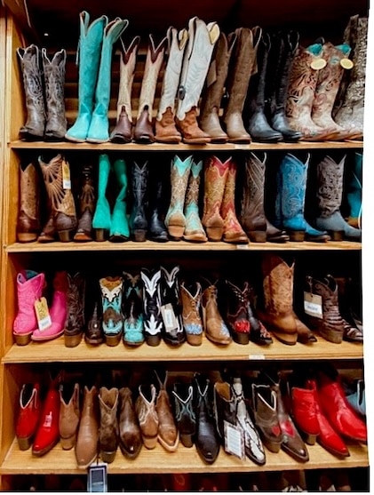 Rows of shelving displaying colorful cowboy boots at Allens Boots in Austin Texas