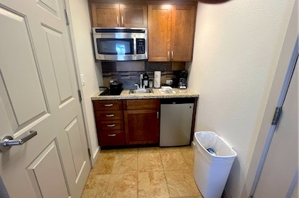 Convenient kitchenette with mini fridge, mircrowae stovetop and wood cabinets in a Studio at the Hilton Vacation Club Lake Tahoe Resort.