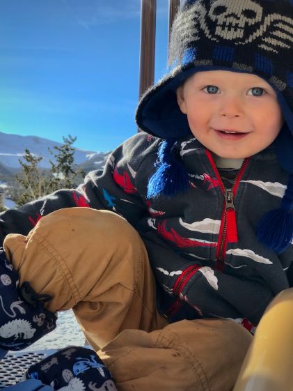 A smiling child in snow gear