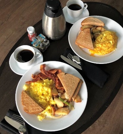 Room service breakfast of eggs, bacon, toast, potatoes, and coffee at Las Palmeras, a Hilton Grand Vacations Club