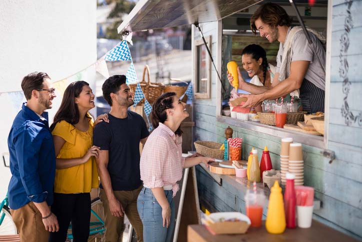 Tourists order food at a food truck