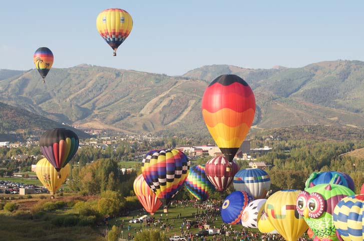 Hot air balloons flying over Park City, Utah in fall. 