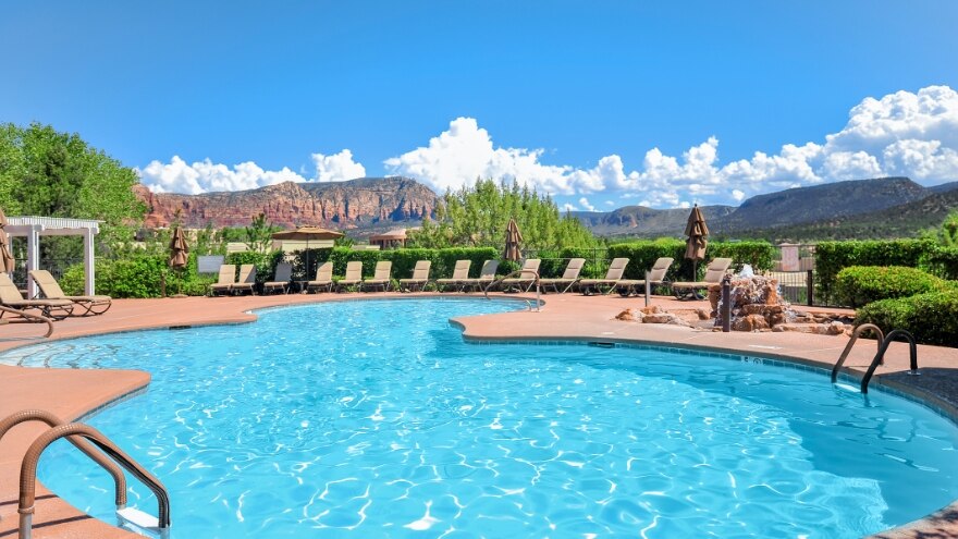 Pool surrounded by lounge chairs at Ridge on Sedona, a Hilton Vacation Club located in Arizona