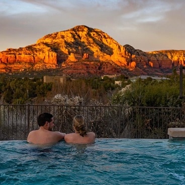 Couple in a hot tub looking at Arizona mountains