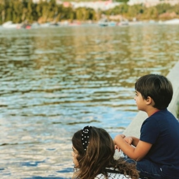 Two kids looking at a lake by Tremblant, a Hilton Grand Vacations Club.