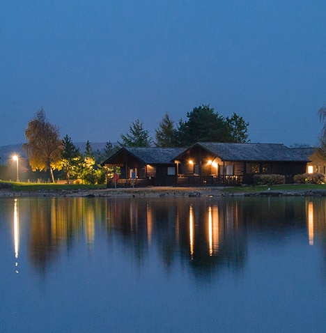 Pine Lake Resort lake at night with cabins on far shore