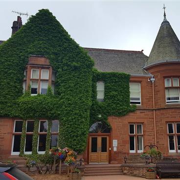 Ivy covered building at Craigendarroch Suites, a Hilton Grand Vacations Club located in Ballater, Scotland, U.K.