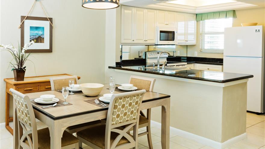 Kitchen and dining area at The Charter Club of Marco Beach located in Florida.