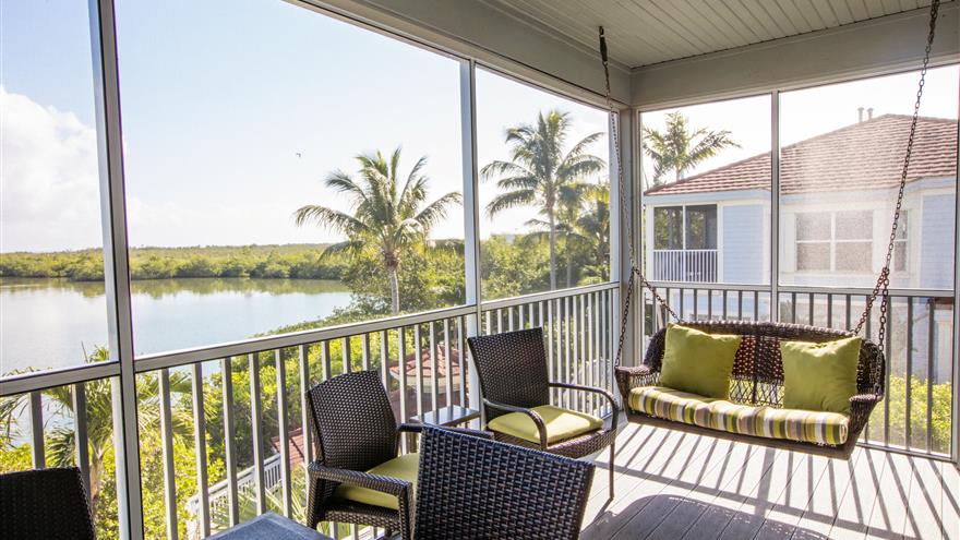 Porch with a swinging bench and ocean view at Plantation Bay Villas at South Seas Island Resort located at Captiva Island, Florida